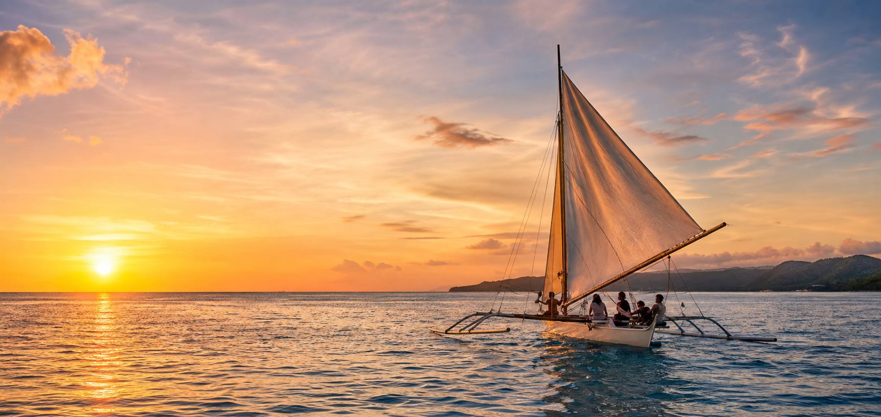 Traditional paraw sailboat near Boracay at sunset
